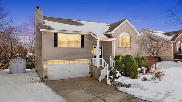 view of front of property featuring a storage unit and a garage