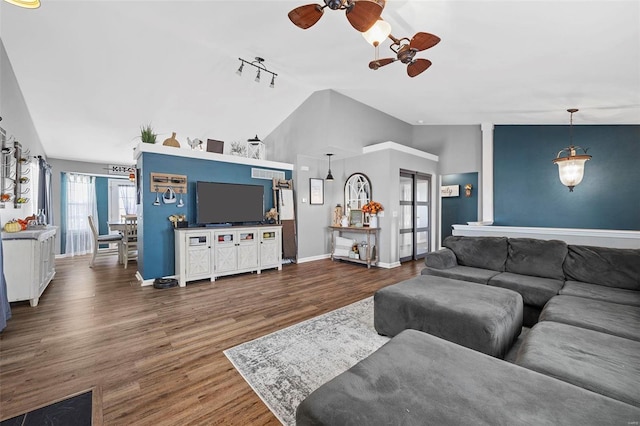 living room with ceiling fan, dark hardwood / wood-style flooring, rail lighting, and lofted ceiling