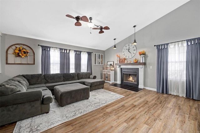 living room featuring hardwood / wood-style flooring, ceiling fan, and lofted ceiling