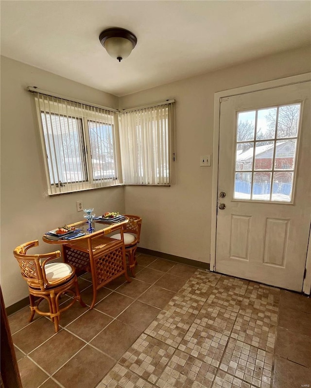 dining room featuring dark tile patterned floors