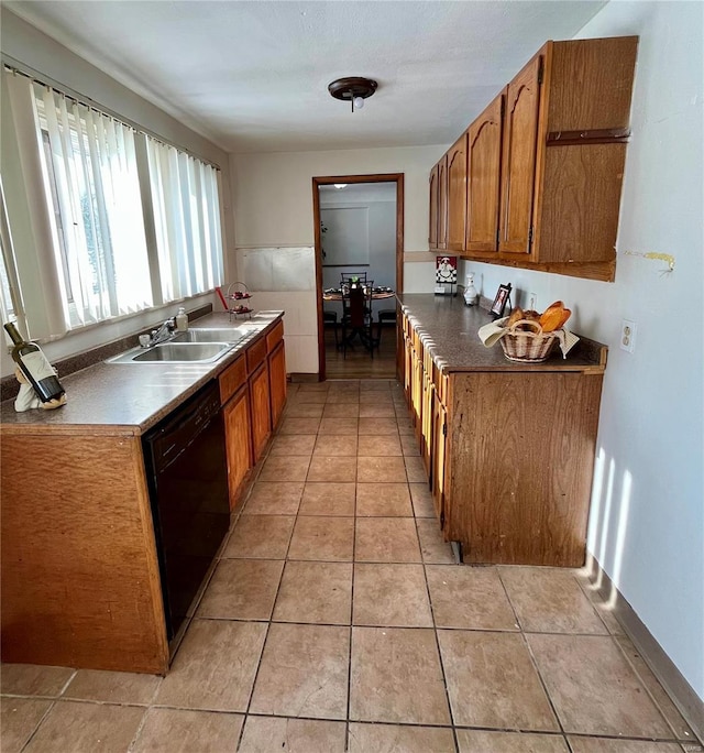 kitchen featuring dishwasher, light tile patterned floors, and sink