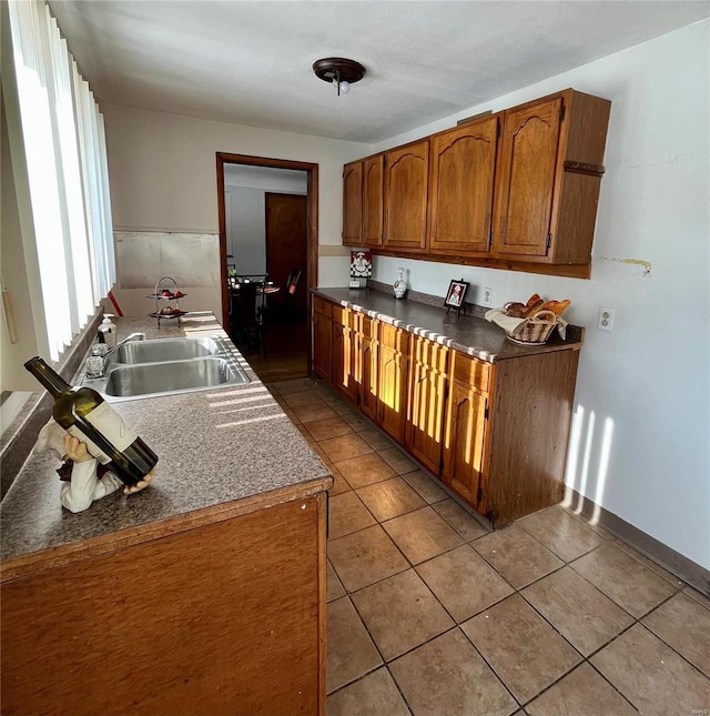 kitchen featuring a wealth of natural light, sink, and light tile patterned flooring