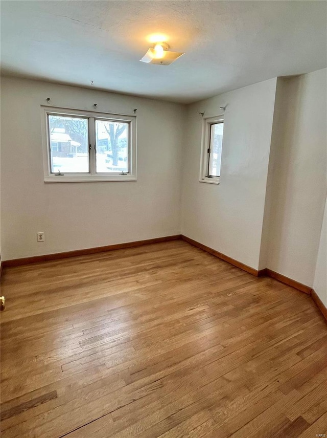 spare room with light hardwood / wood-style flooring