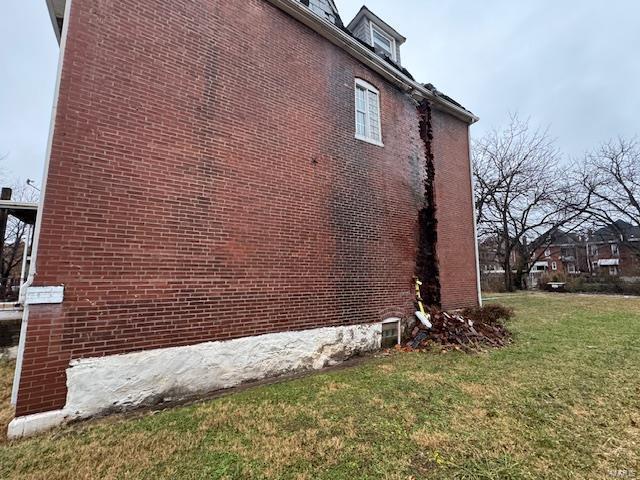 view of side of home featuring a lawn