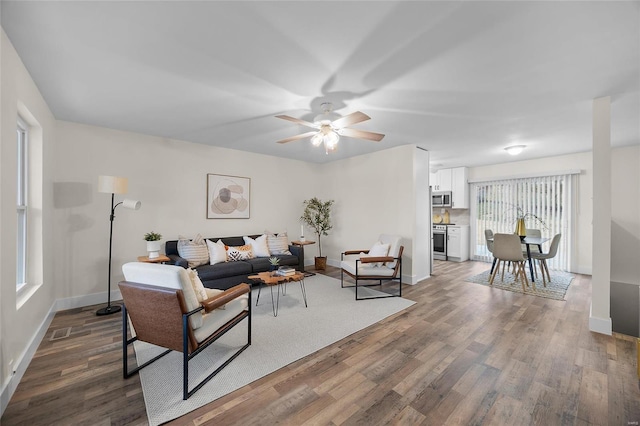 living room featuring hardwood / wood-style floors and ceiling fan