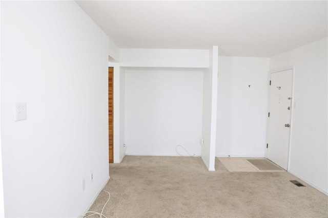 empty room featuring light colored carpet