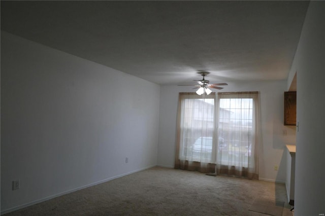 unfurnished room with ceiling fan and light colored carpet