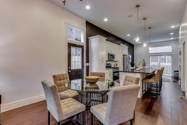 dining area featuring dark hardwood / wood-style flooring and sink