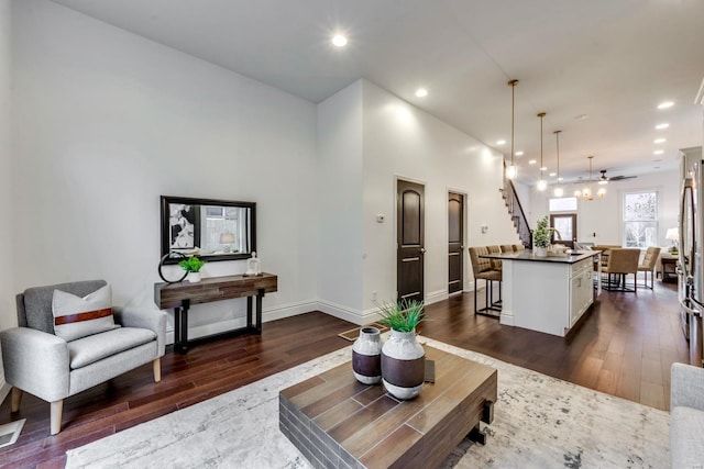 living room featuring dark hardwood / wood-style floors and ceiling fan