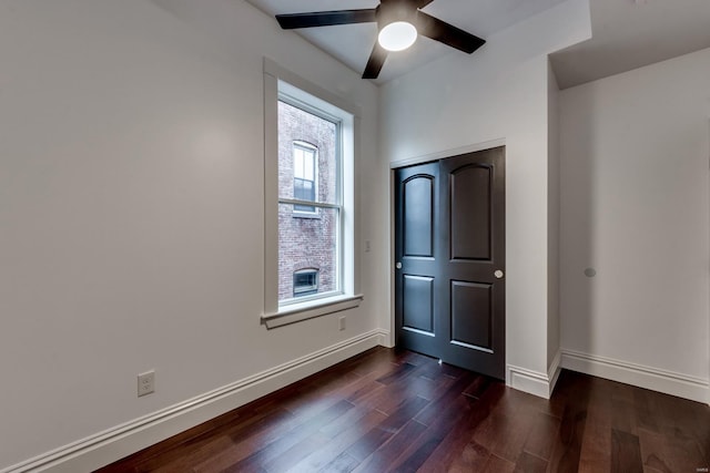 interior space featuring ceiling fan and dark wood-type flooring