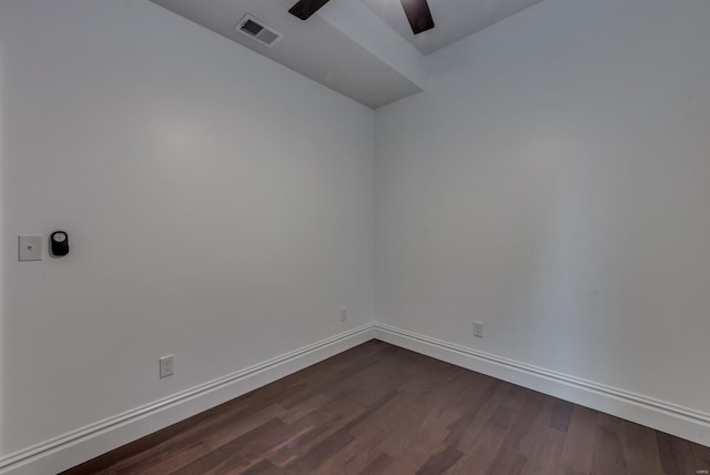 empty room with ceiling fan and dark hardwood / wood-style flooring