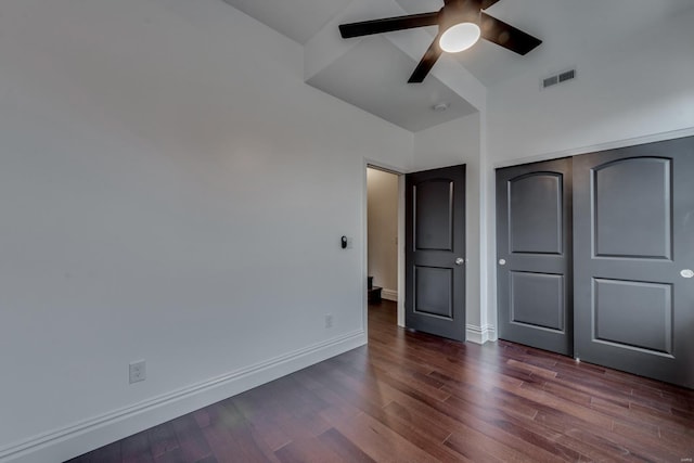 unfurnished bedroom featuring ceiling fan, a closet, and dark hardwood / wood-style floors