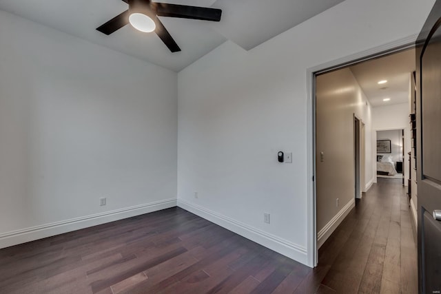 spare room featuring ceiling fan and dark hardwood / wood-style floors