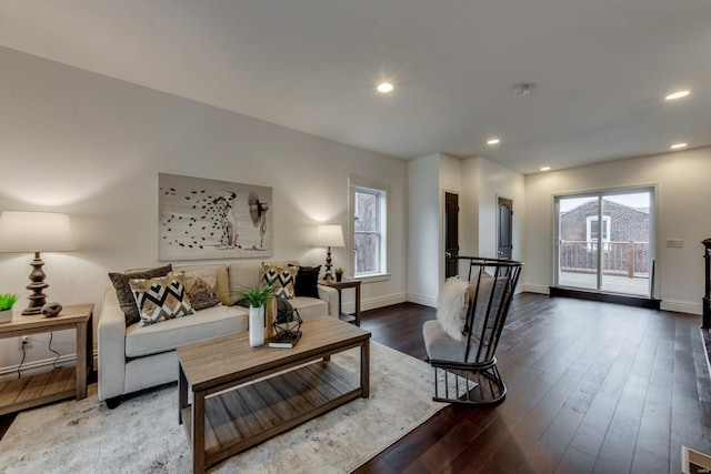 living room featuring dark hardwood / wood-style floors and plenty of natural light