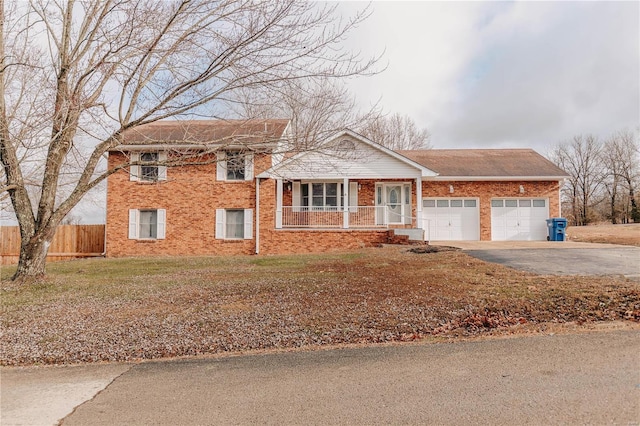 view of front facade featuring a garage, a front yard, and a porch