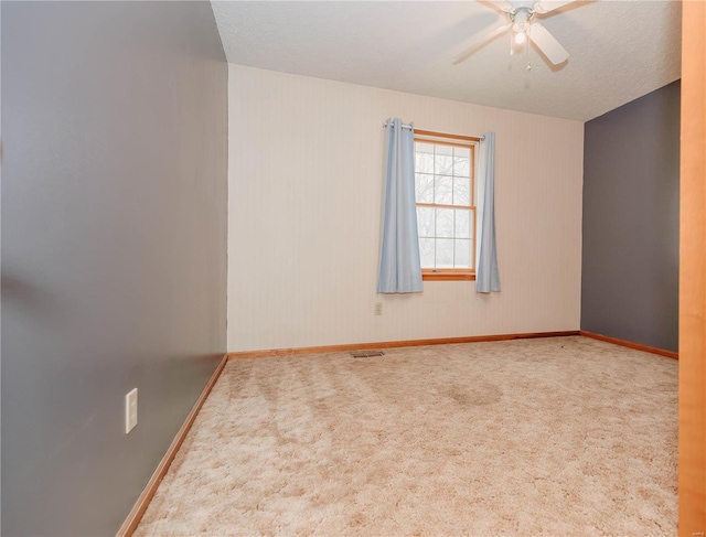 spare room featuring ceiling fan and carpet flooring