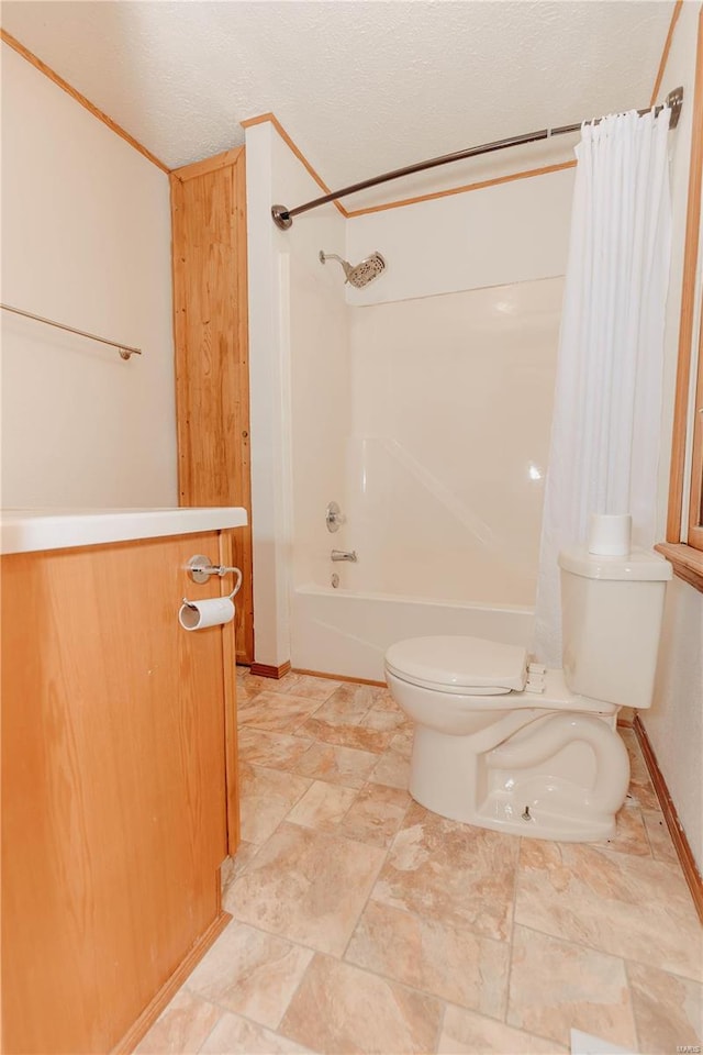 full bathroom with shower / tub combo with curtain, vanity, toilet, and a textured ceiling