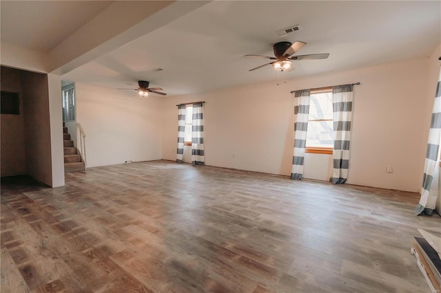 unfurnished living room with wood-type flooring and ceiling fan