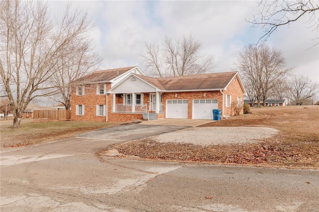 view of front facade with a garage, covered porch, and a front lawn