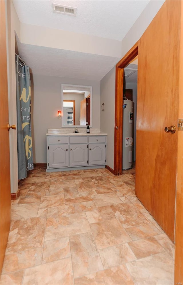 bathroom featuring vanity and electric water heater