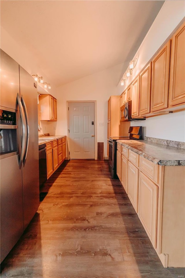 kitchen featuring hardwood / wood-style flooring, vaulted ceiling, light brown cabinetry, and black appliances