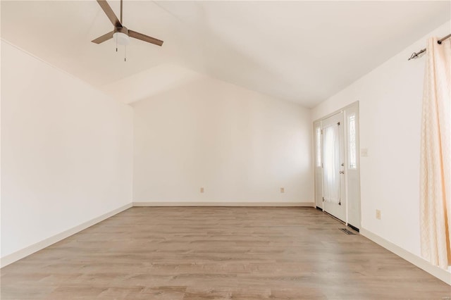 unfurnished room with light wood finished floors, visible vents, baseboards, ceiling fan, and vaulted ceiling