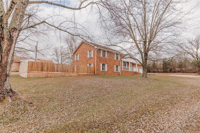 exterior space with brick siding and fence