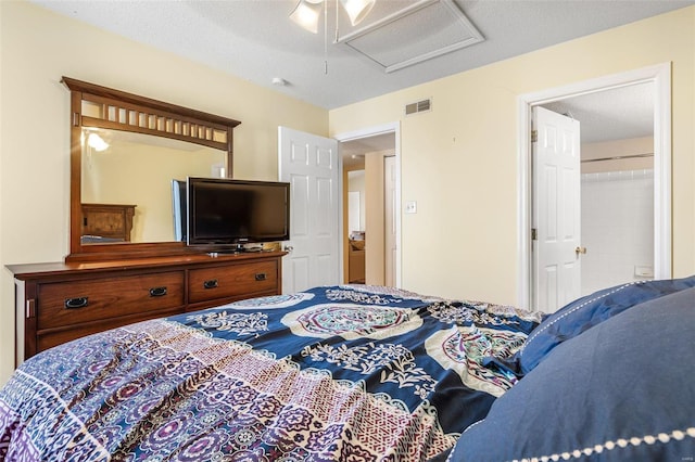 bedroom with ceiling fan and a textured ceiling