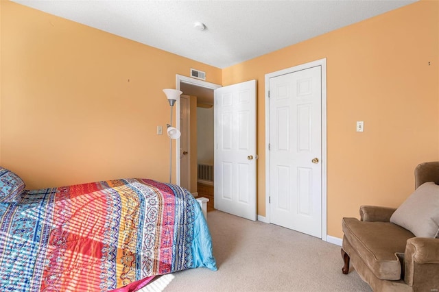 bedroom featuring light carpet