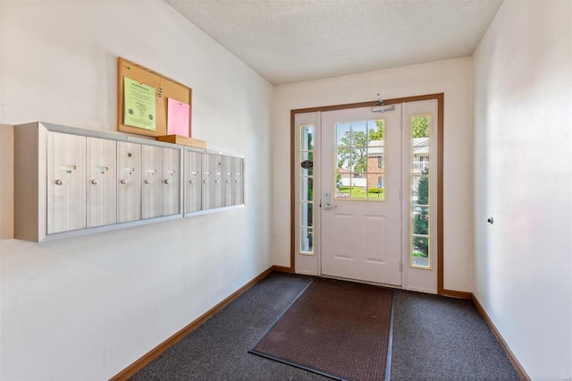 interior space featuring a textured ceiling and carpet