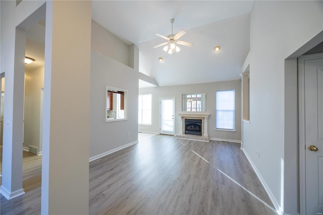 unfurnished living room featuring ceiling fan, high vaulted ceiling, and light hardwood / wood-style flooring