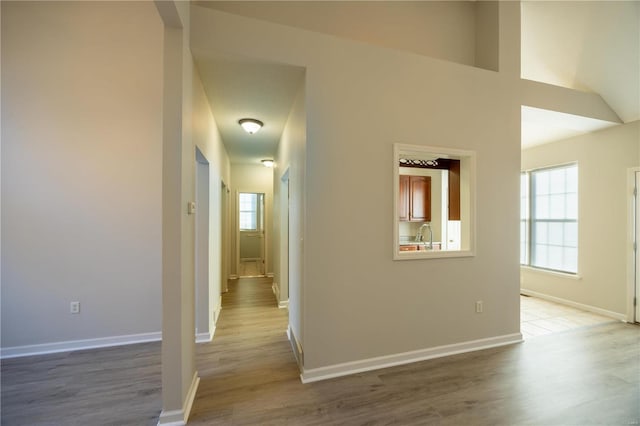 hallway featuring light hardwood / wood-style floors and sink