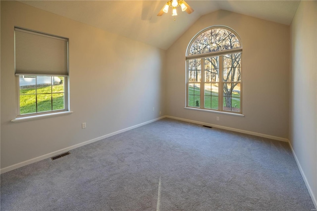 spare room featuring carpet, ceiling fan, and lofted ceiling