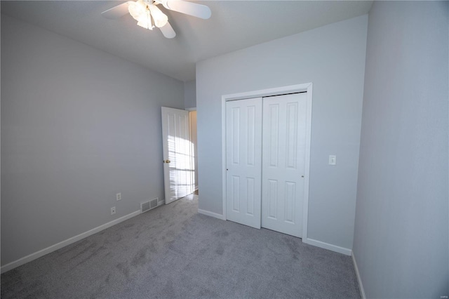 unfurnished bedroom with carpet flooring, ceiling fan, and a closet