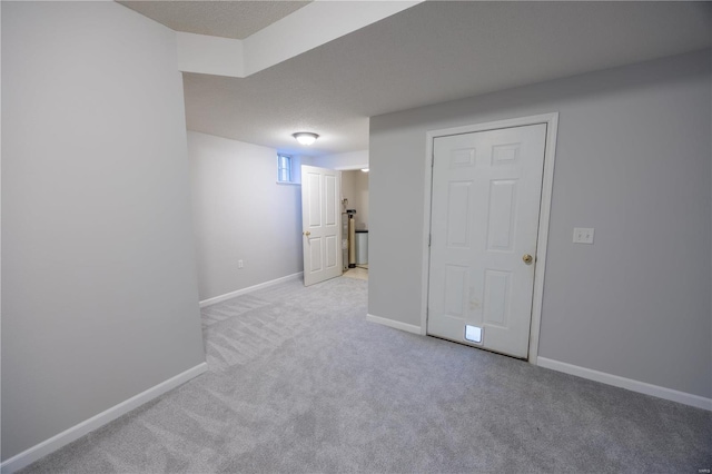 unfurnished room with a textured ceiling and light carpet