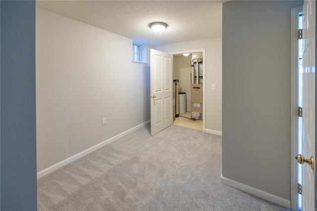 interior space with light carpet and a textured ceiling