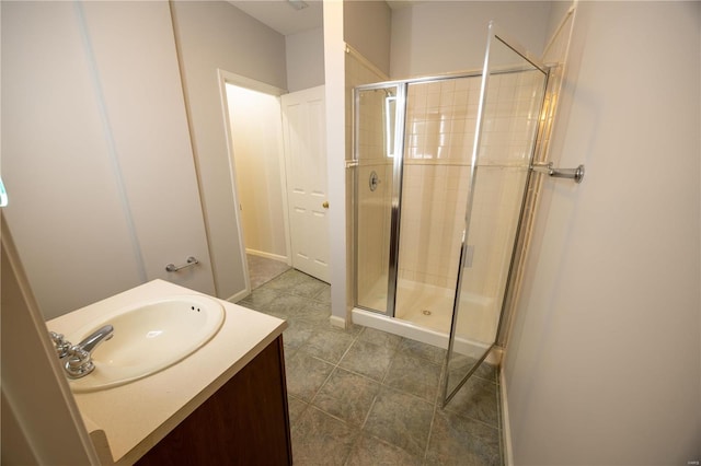 bathroom featuring vanity and a shower with shower door