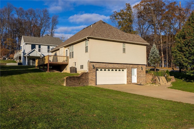 view of property exterior featuring central AC, a yard, a garage, and a wooden deck