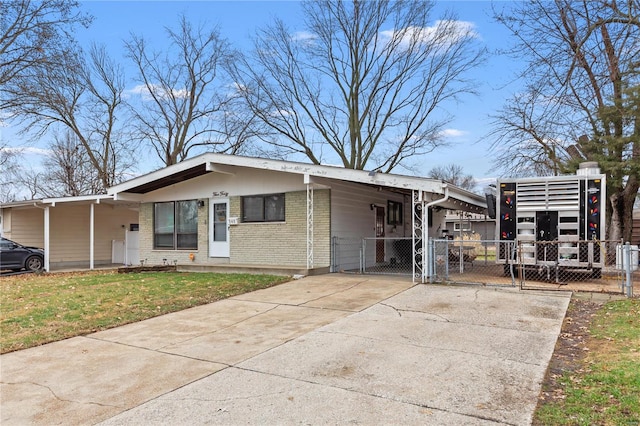 view of front of home with a front lawn and a carport