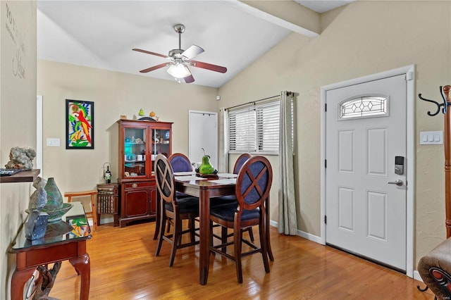 dining room featuring lofted ceiling with beams, light hardwood / wood-style flooring, and ceiling fan