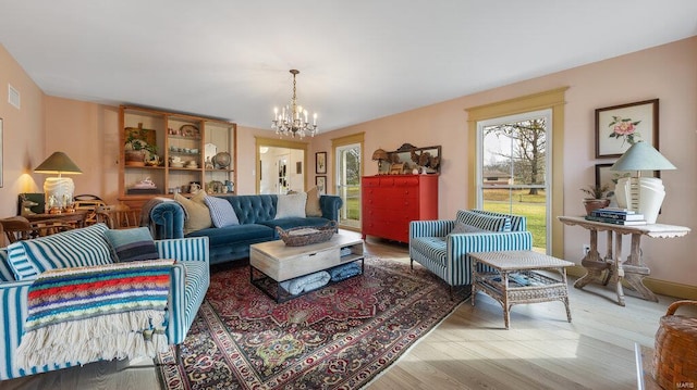 living room featuring a chandelier and hardwood / wood-style floors