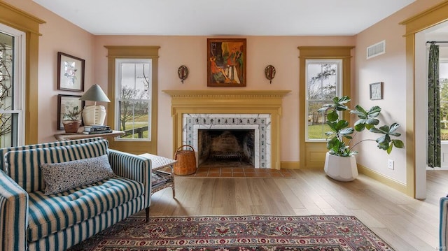 sitting room with a fireplace and light hardwood / wood-style floors