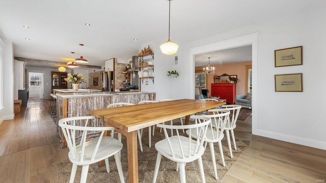 dining area featuring a chandelier and light hardwood / wood-style flooring