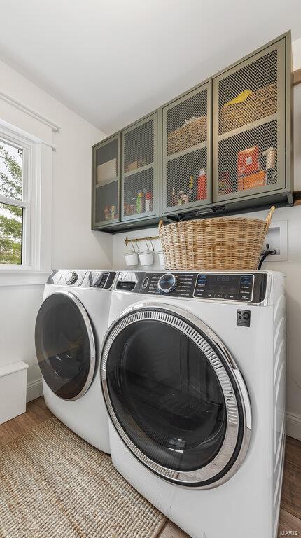 washroom with washer and clothes dryer and wood-type flooring