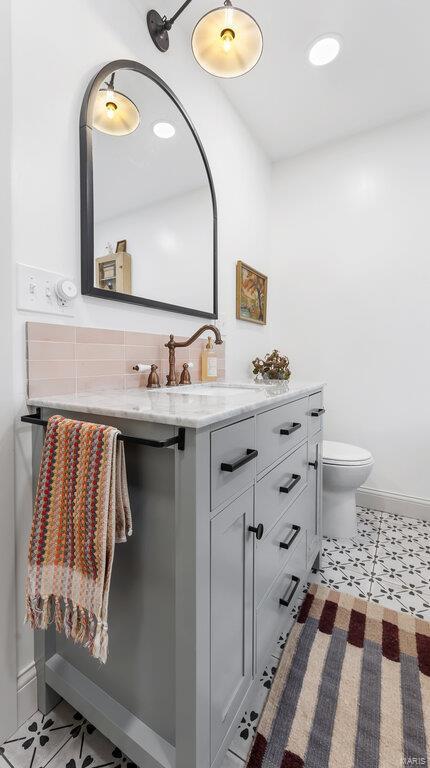 bathroom featuring vanity and toilet