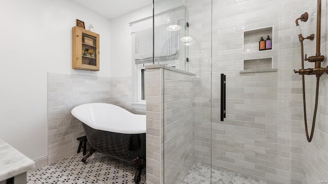 bathroom featuring separate shower and tub and tile walls