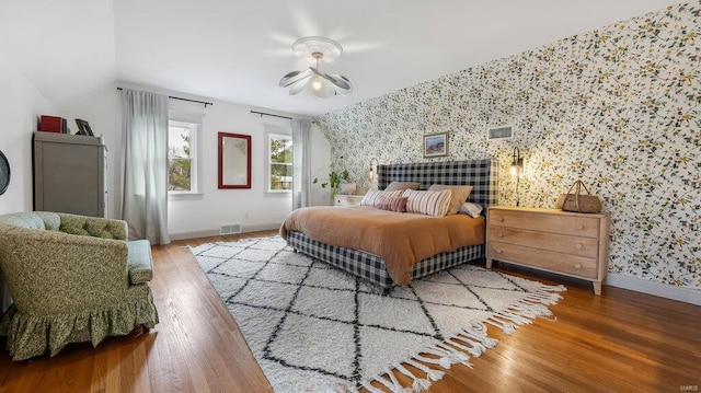 bedroom with hardwood / wood-style floors, ceiling fan, and lofted ceiling