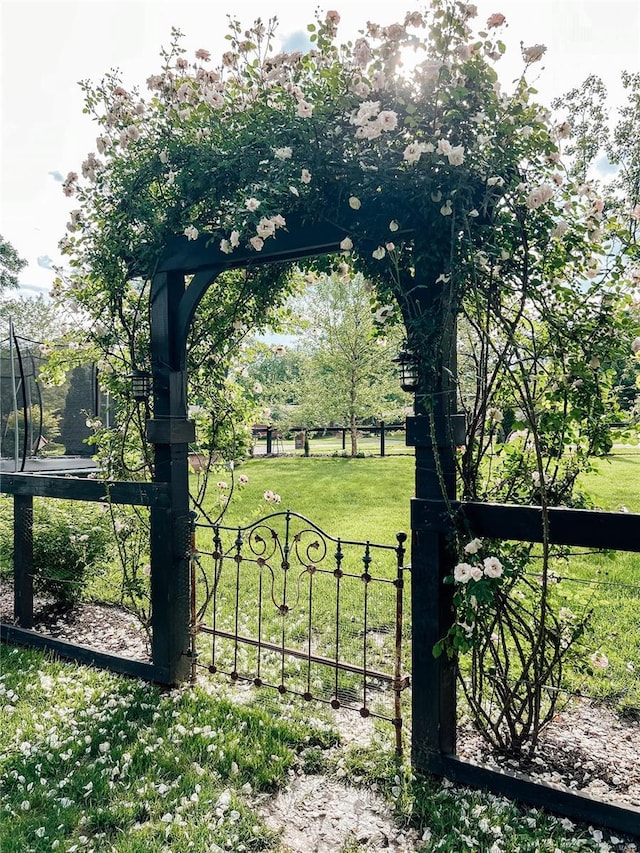 view of gate featuring a lawn