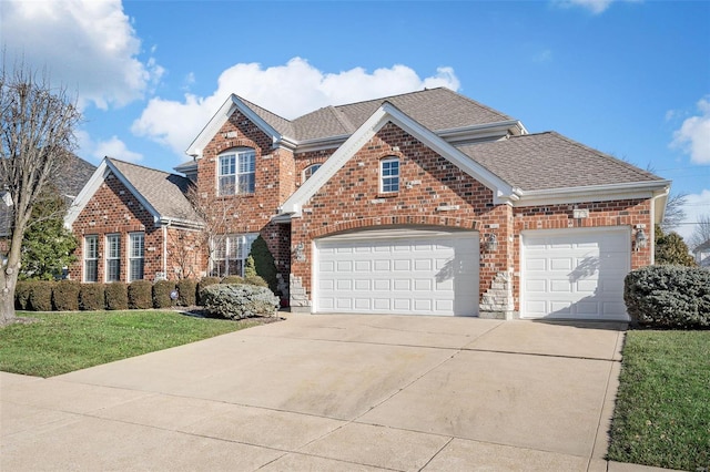 view of property with a front lawn and a garage