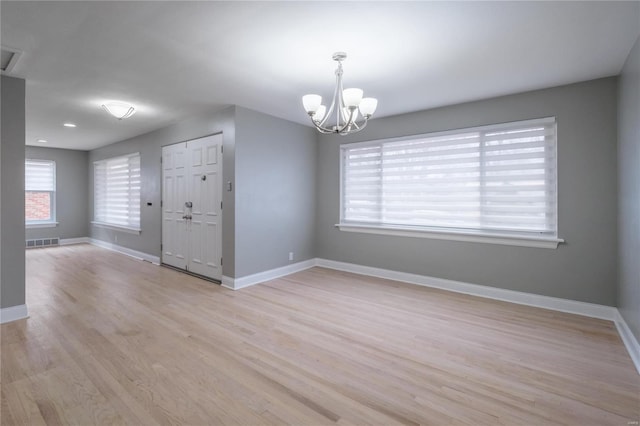 interior space with a chandelier and light hardwood / wood-style flooring